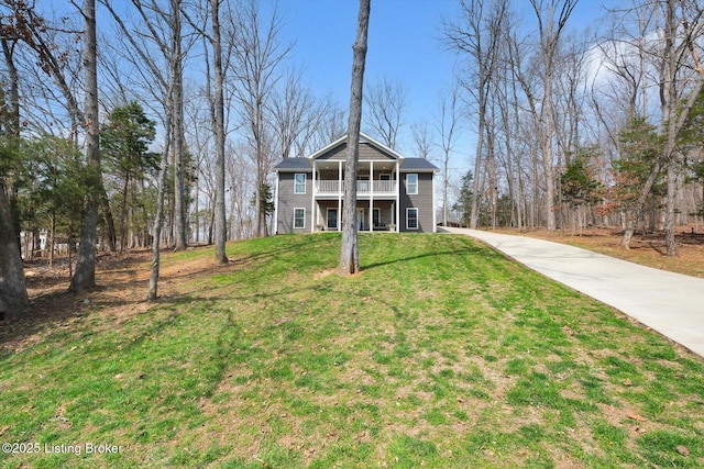 100 Bellemeade St, Brandenburg, KY 40108 - view of front of house featuring a front lawn, driveway, and a balcony
