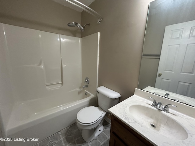 bathroom with toilet, vanity, tile patterned flooring, and washtub / shower combination