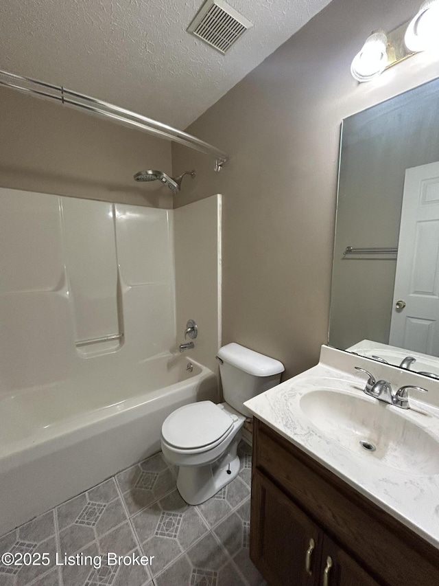 full bathroom with vanity, toilet, a textured ceiling, tile patterned floors, and visible vents