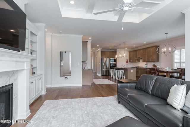 11125 Radleigh Ln, Louisville, KY 40291 - living area with a chandelier, a ceiling fan, wood finished floors, recessed lighting, and crown molding