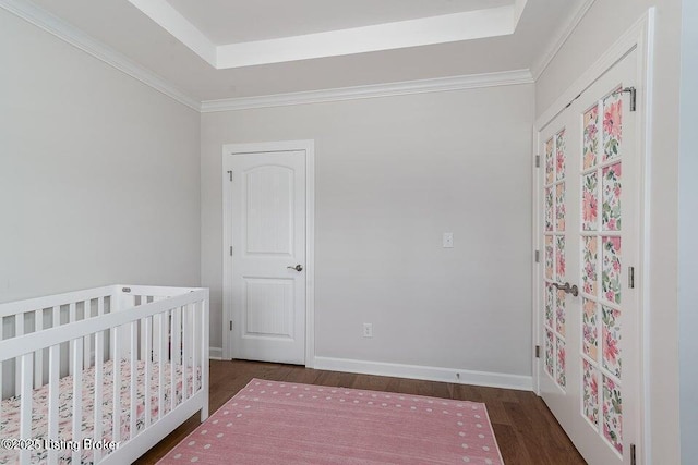 11125 Radleigh Ln, Louisville, KY 40291 - bedroom with wood finished floors, a tray ceiling, a crib, and baseboards