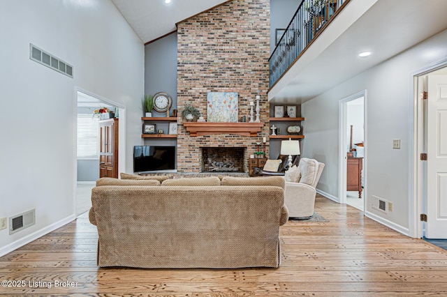 1014 Old Mill Stream Ln, Shepherdsville, KY 40165 - living area featuring high vaulted ceiling, a brick fireplace, hardwood / wood-style floors, and baseboards