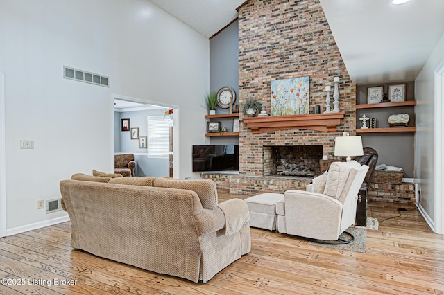 1014 Old Mill Stream Ln, Shepherdsville, KY 40165 - living room featuring high vaulted ceiling, hardwood / wood-style floors, baseboards, and a fireplace