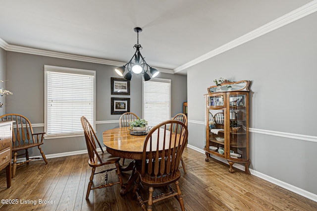 1014 Old Mill Stream Ln, Shepherdsville, KY 40165 - dining room featuring hardwood / wood-style floors, a chandelier, crown molding, plenty of natural light, and baseboards