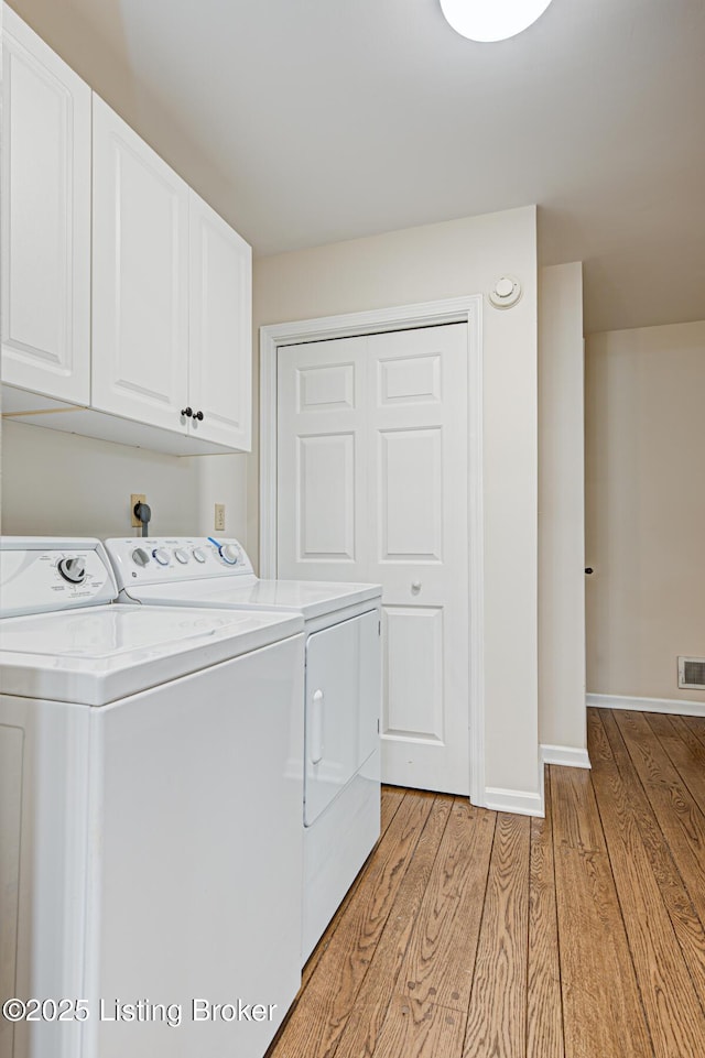 1014 Old Mill Stream Ln, Shepherdsville, KY 40165 - washroom with washing machine and dryer, light wood-type flooring, cabinet space, and baseboards