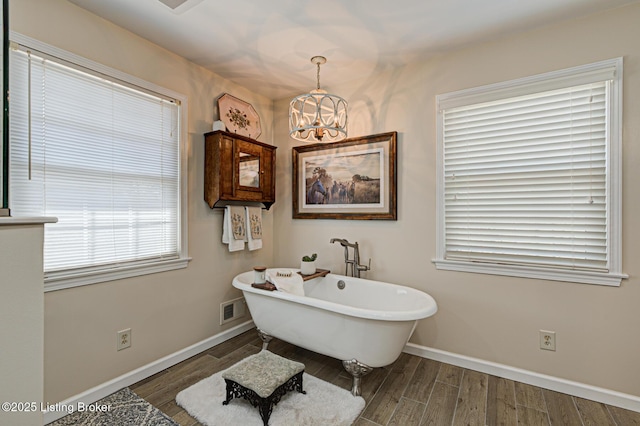 1014 Old Mill Stream Ln, Shepherdsville, KY 40165 - full bathroom with a chandelier, a freestanding bath, baseboards, and wood finished floors