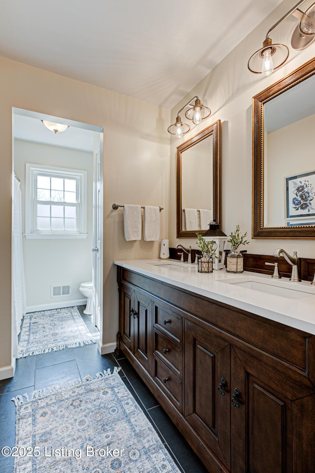 1014 Old Mill Stream Ln, Shepherdsville, KY 40165 - bathroom with double vanity, toilet, tile patterned flooring, and baseboards