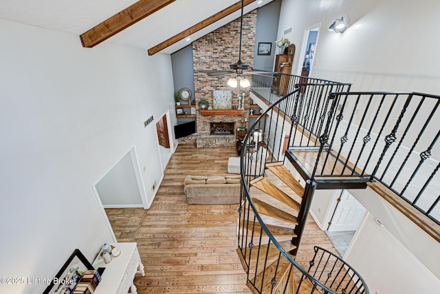 1014 Old Mill Stream Ln, Shepherdsville, KY 40165 - stairs with hardwood / wood-style flooring, ceiling fan, beamed ceiling, high vaulted ceiling, and a fireplace