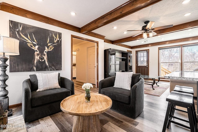 living room featuring recessed lighting, beamed ceiling, and baseboards