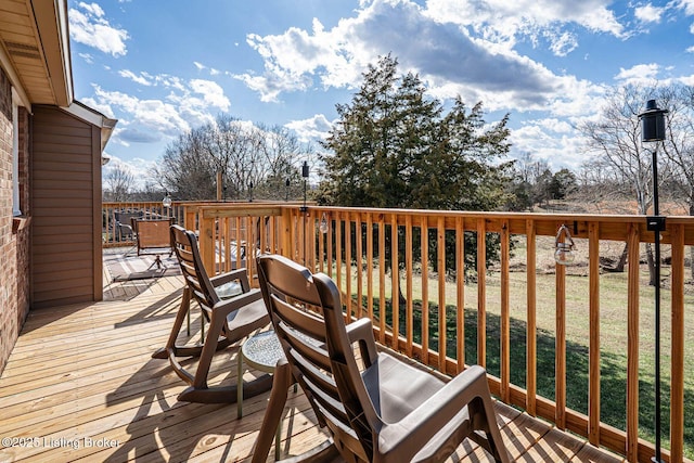 wooden terrace with a yard