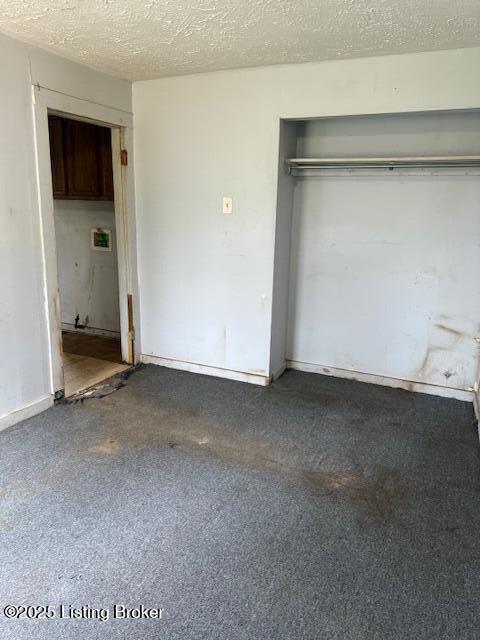 unfurnished bedroom with a closet and a textured ceiling