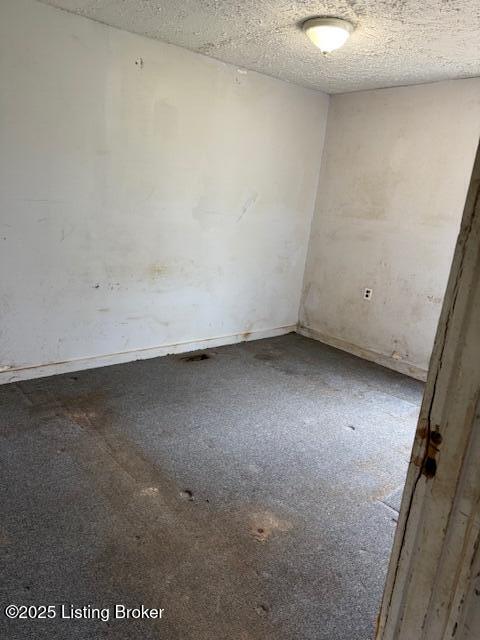 spare room with a textured ceiling