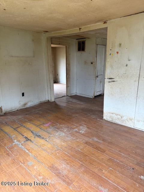 unfurnished room with hardwood / wood-style floors