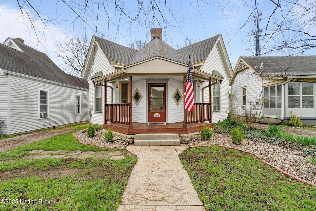 28 7th St, Shelbyville, KY 40065 - view of front of home featuring a porch, a chimney, roof with shingles, and a sunroom