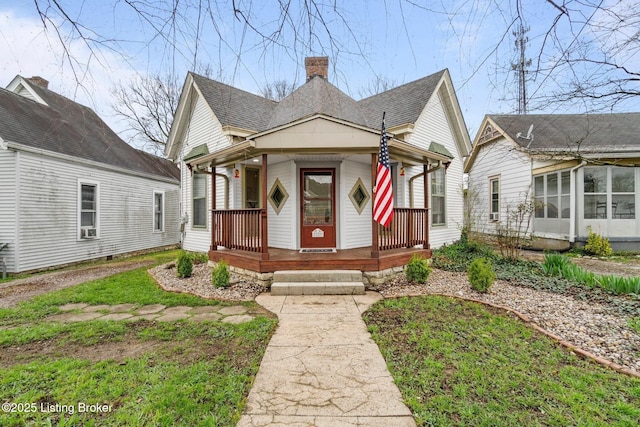 28 7th St, Shelbyville, KY 40065 - view of front of home featuring a porch, a chimney, roof with shingles, and a sunroom