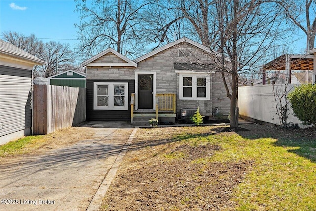 706 W Whitney Ave, Louisville, KY 40215 - view of front of house with stone siding, fence, and cooling unit