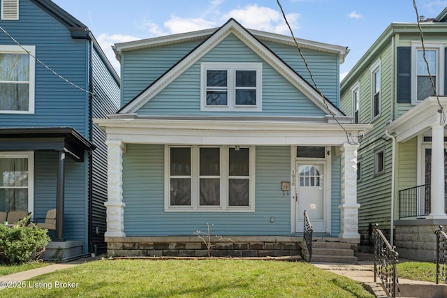 view of front facade featuring covered porch and a front lawn