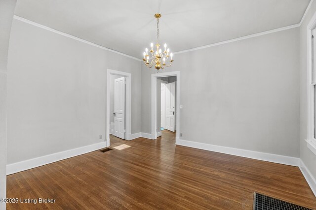 unfurnished dining area featuring an inviting chandelier, ornamental molding, visible vents, wood finished floors, and baseboards
