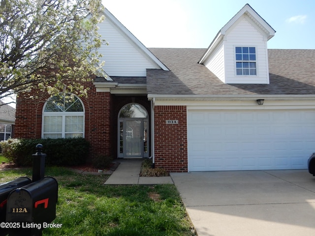 113 Lanai Dr Unit A, Shepherdsville, KY 40165 - view of front of house featuring an attached garage, a front yard, brick siding, driveway, and a shingled roof