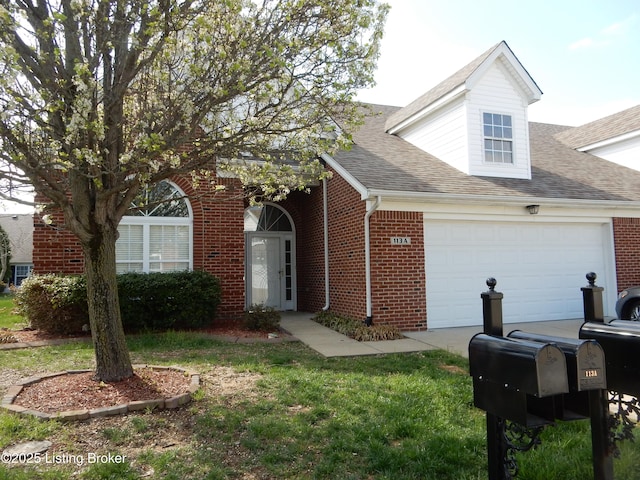 113 Lanai Dr Unit A, Shepherdsville, KY 40165 - view of front of home with an attached garage, a front yard, brick siding, and roof with shingles