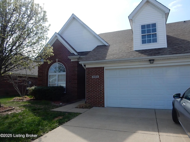 113 Lanai Dr Unit A, Shepherdsville, KY 40165 - view of front of house featuring a shingled roof, a garage, brick siding, and concrete driveway
