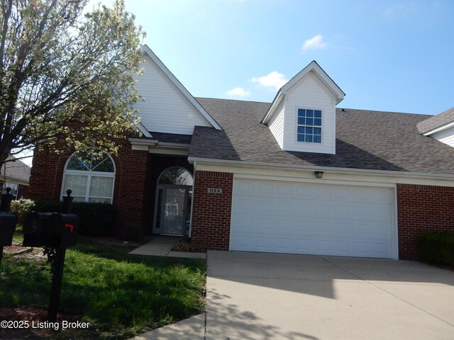 113 Lanai Dr Unit A, Shepherdsville, KY 40165 - view of front of home featuring brick siding, a garage, concrete driveway, and roof with shingles