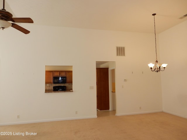 113 Lanai Dr Unit A, Shepherdsville, KY 40165 - unfurnished living room with light colored carpet, ceiling fan with notable chandelier, baseboards, a towering ceiling, and visible vents