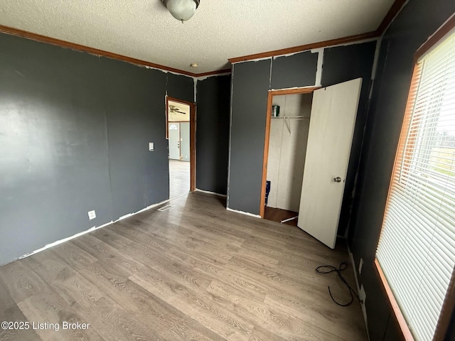 42 Foggy Bottom Ln, Garfield, KY 40140 - unfurnished bedroom featuring a closet, a textured ceiling, wood finished floors, and ornamental molding