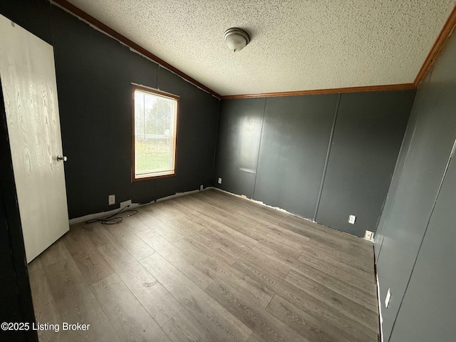 42 Foggy Bottom Ln, Garfield, KY 40140 - empty room featuring lofted ceiling, crown molding, wood finished floors, and a textured ceiling