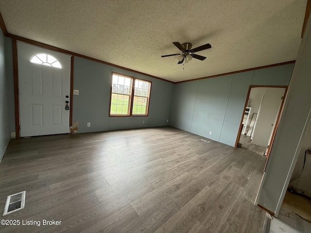 42 Foggy Bottom Ln, Garfield, KY 40140 - entryway with crown molding, a textured ceiling, visible vents, a ceiling fan, and wood finished floors