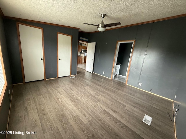 42 Foggy Bottom Ln, Garfield, KY 40140 - unfurnished bedroom with visible vents, wood finished floors, ornamental molding, and a textured ceiling