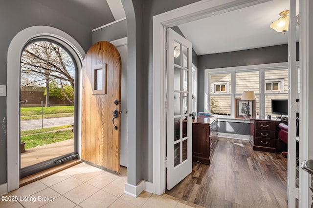 4613 S 2nd St, Louisville, KY 40214 - entryway featuring baseboards, wood finished floors, and arched walkways