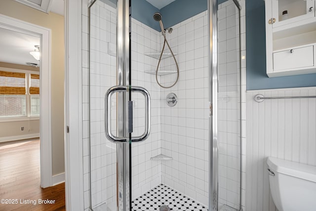 4613 S 2nd St, Louisville, KY 40214 - bathroom with wood finished floors, toilet, and a shower stall