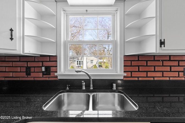 kitchen with white cabinets, tasteful backsplash, a sink, and open shelves