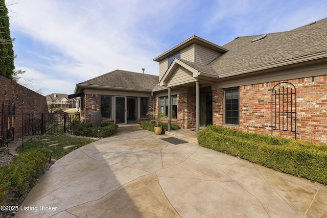 12206 Bridgeway Ct, Sellersburg, IN 47172 - rear view of house with a gate, a shingled roof, fence, and brick siding