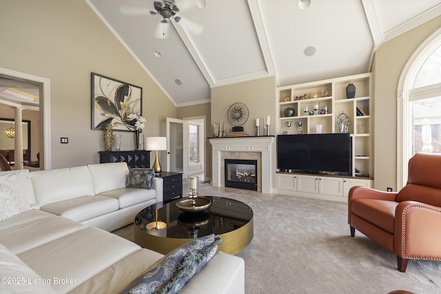 12206 Bridgeway Ct, Sellersburg, IN 47172 - carpeted living area featuring high vaulted ceiling, a high end fireplace, crown molding, ceiling fan, and decorative columns