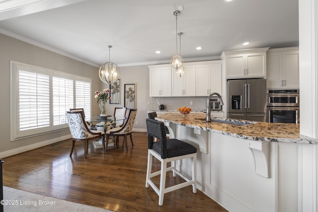 12206 Bridgeway Ct, Sellersburg, IN 47172 - kitchen featuring white cabinetry, crown molding, backsplash, and stainless steel appliances