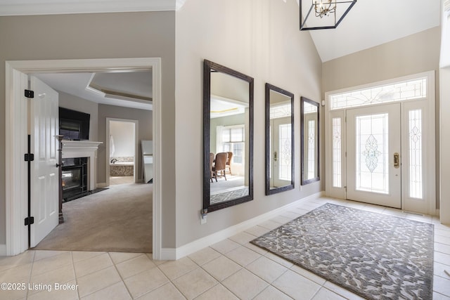 12206 Bridgeway Ct, Sellersburg, IN 47172 - entrance foyer with a tray ceiling, high vaulted ceiling, light carpet, light tile patterned floors, and baseboards