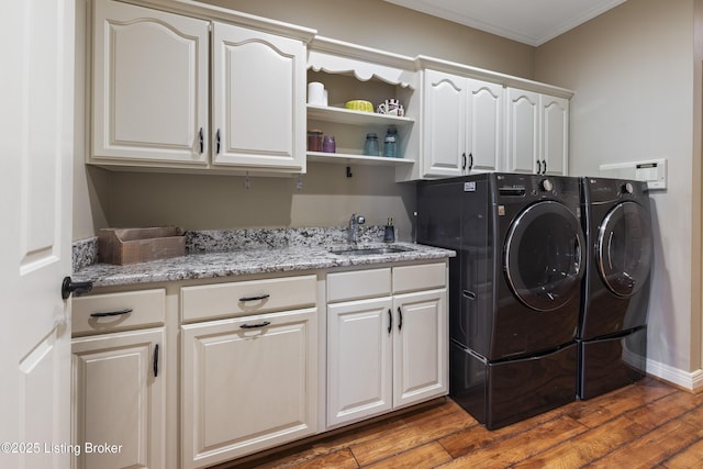12206 Bridgeway Ct, Sellersburg, IN 47172 - washroom with ornamental molding, wood finished floors, washing machine and dryer, a sink, and cabinet space