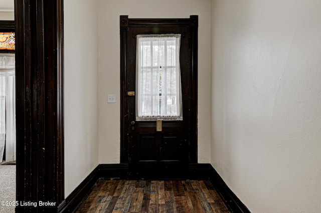 entryway featuring dark wood-style floors and baseboards