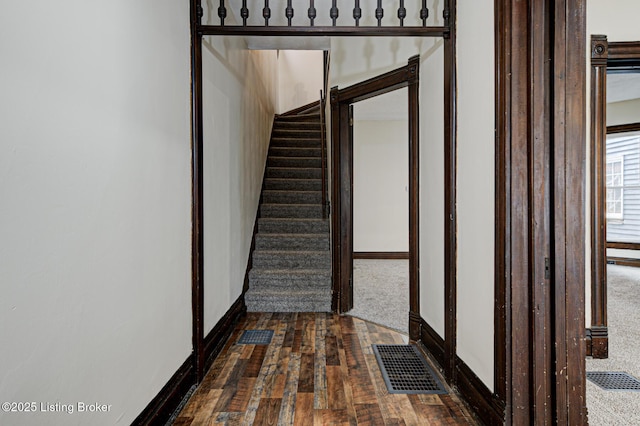 interior space featuring baseboards, visible vents, and hardwood / wood-style flooring