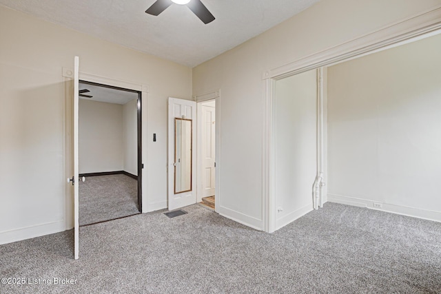 unfurnished bedroom featuring carpet floors, baseboards, a closet, and ceiling fan