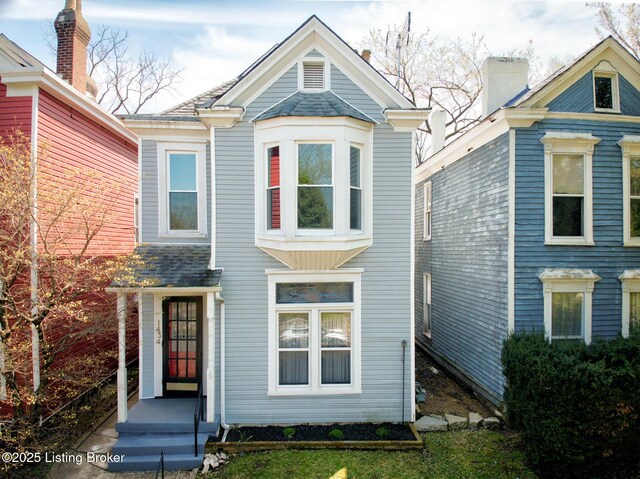 view of front of home featuring a chimney