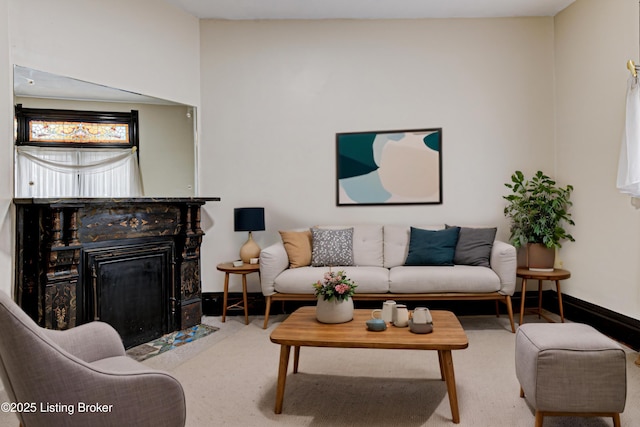living room with a fireplace with flush hearth, baseboards, and carpet flooring