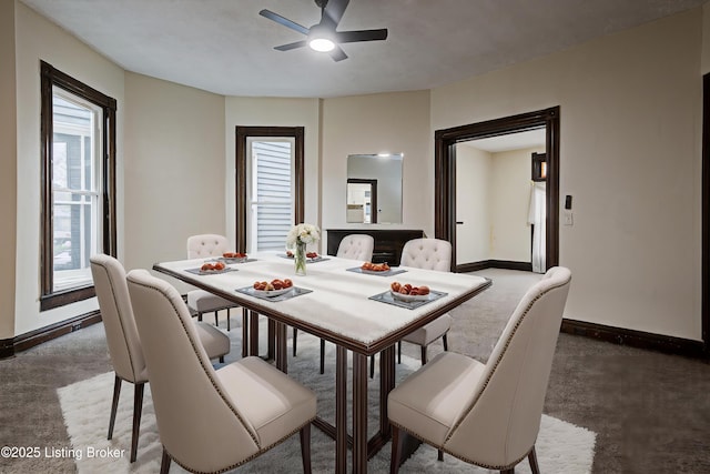 dining area featuring baseboards and ceiling fan
