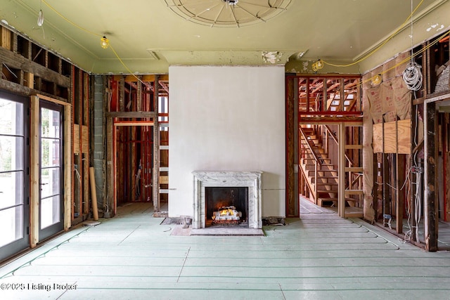 1801 Sulgrave Rd, Louisville, KY 40205 - unfurnished living room featuring a high end fireplace, stairway, and hardwood / wood-style flooring
