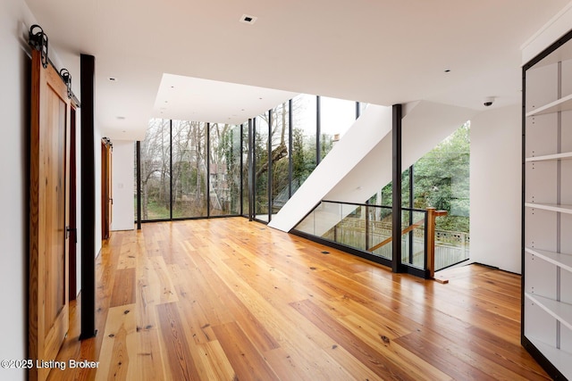 1801 Sulgrave Rd, Louisville, KY 40205 - interior space featuring floor to ceiling windows, a barn door, and wood-type flooring