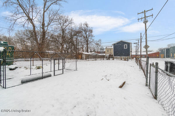 2842 Slevin St, Louisville, KY 40212 - yard layered in snow with fence and an outdoor structure