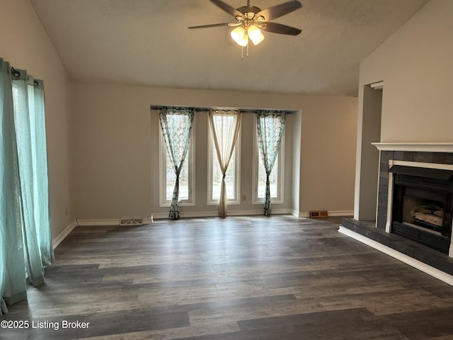 386 Pine Ridge Dr, Brandenburg, KY 40108 - unfurnished living room featuring vaulted ceiling, a tiled fireplace, a ceiling fan, wood finished floors, and visible vents