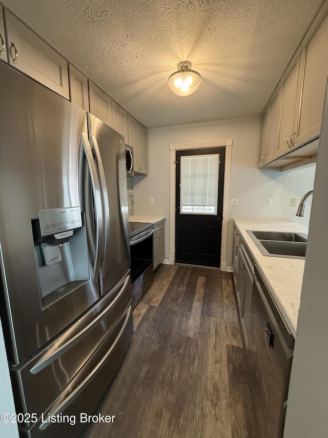 386 Pine Ridge Dr, Brandenburg, KY 40108 - kitchen featuring dark wood-style flooring, a textured ceiling, light countertops, appliances with stainless steel finishes, and a sink